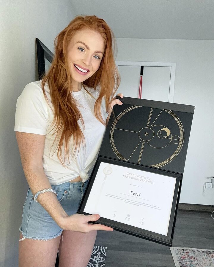 Customer holding a framed star certificate in its gift box